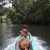 going up river in a long boat in Borneo