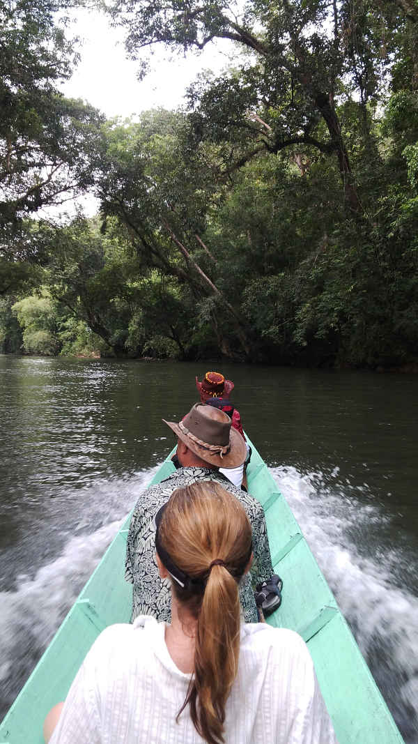 going up river in a long boat in Borneo