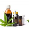 A marijuan leaf in front of bottles medical cannabis and CBD oil